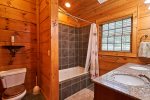 The private bath downstairs also has twin sinks and a tiled tub/shower.